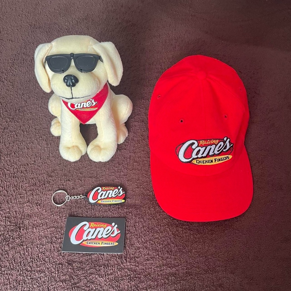 Raising Cane's Merchandise Set of Dog Plushie, Baseball Cap, Magnet, & Keychain